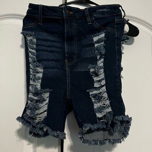 Never worn size 11 blue jeans shorts with holes up the front and back.